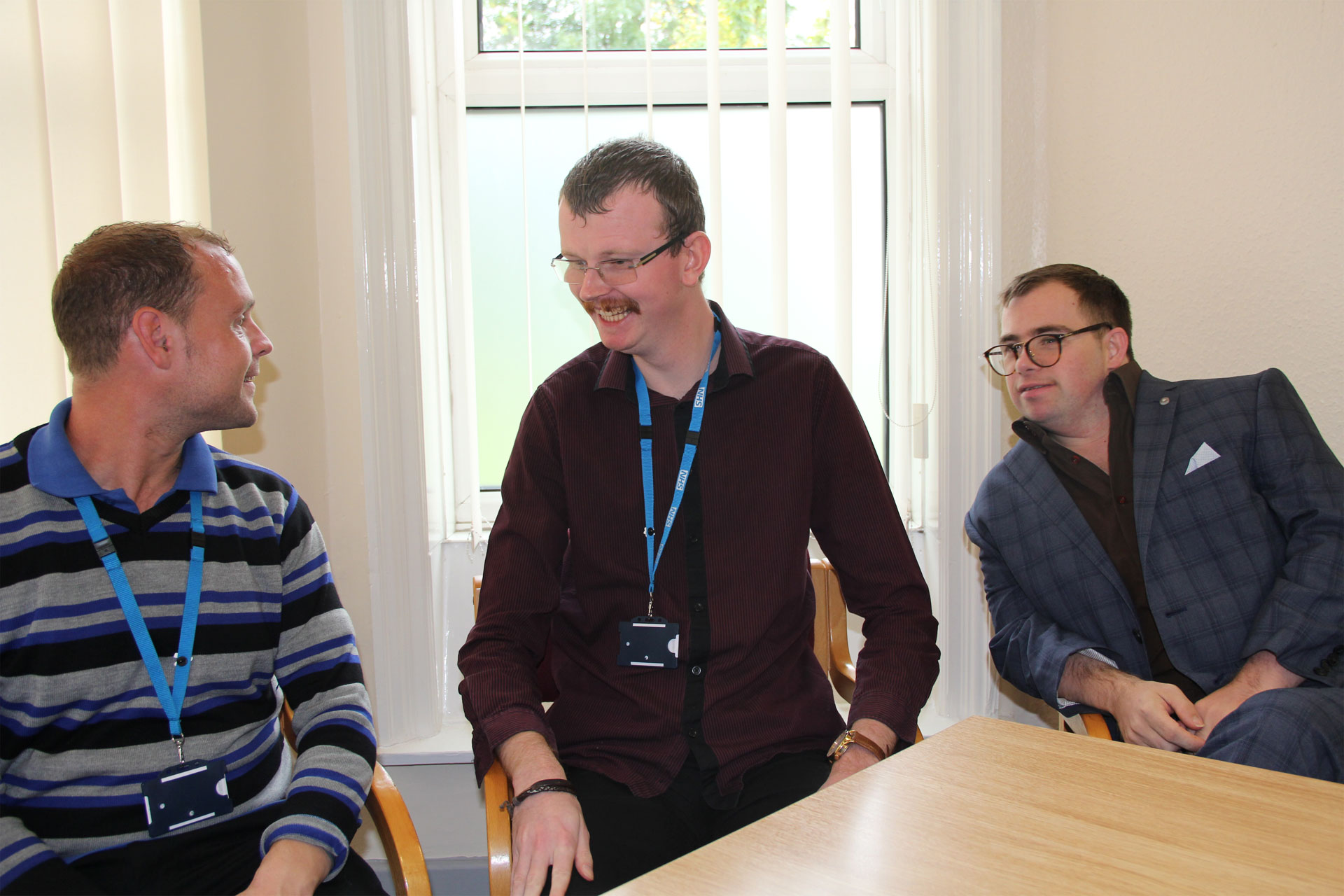 three-learning-disabilities-colleagues-sitting-talking-smiling.JPG
