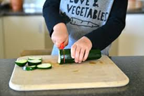 a child cutting a piece of food